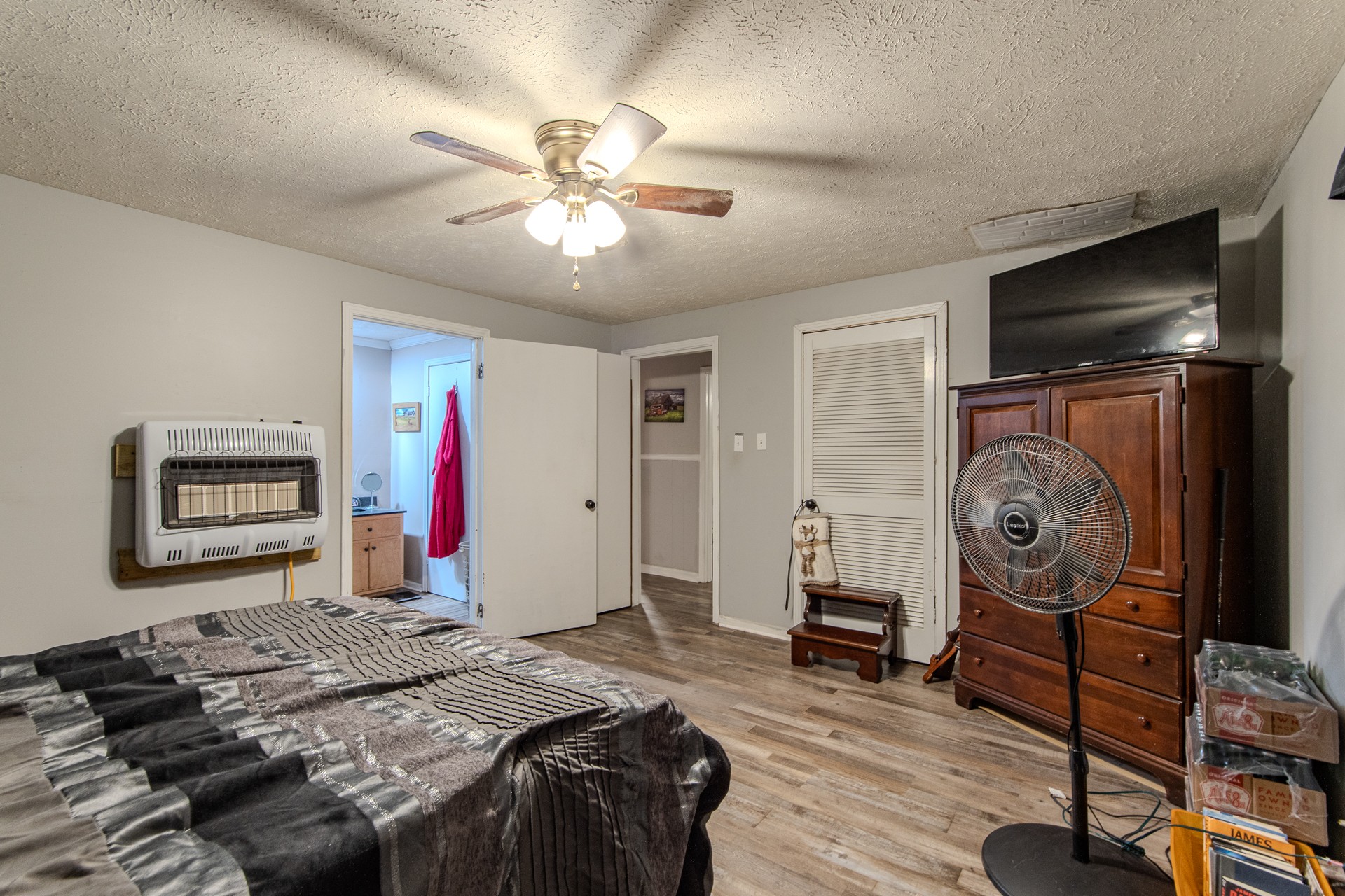 320 Rabbit Ranch Road Henderson, TN 38340 - Photo 18 of 66 a bedroom with a bed and a chandelier