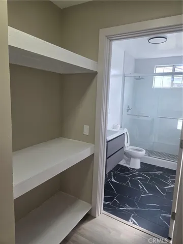 a bathroom with a toilet and a shower