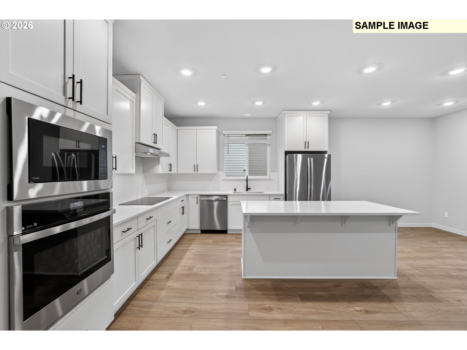 5272 North 87th Avenue Camas, WA 98607 - Photo 13 of 26 a large white kitchen with stainless steel appliances