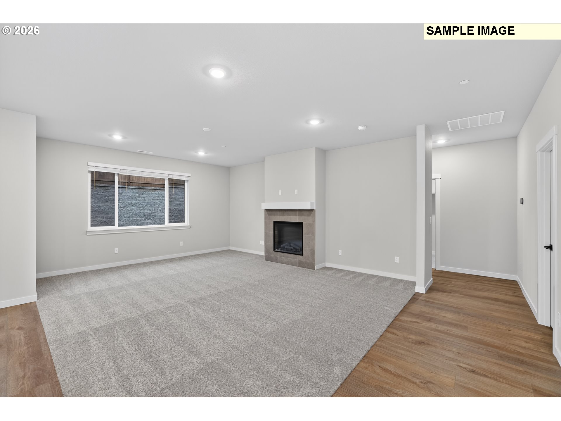 5272 North 87th Avenue Camas, WA 98607 - Photo 3 of 26 a view of an empty room with a fireplace and a window
