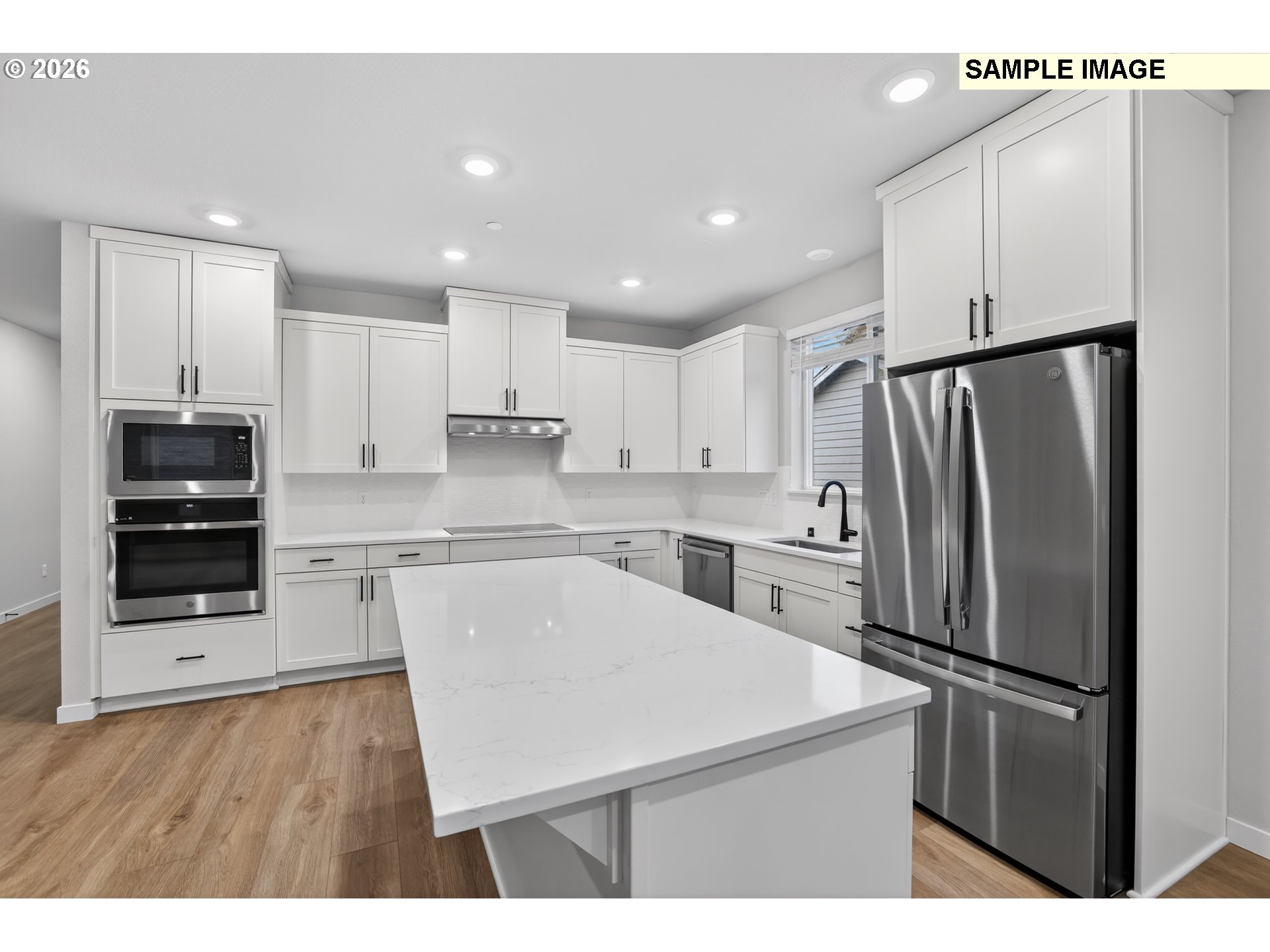 5272 North 87th Avenue Camas, WA 98607 - Photo 7 of 26 a kitchen with a refrigerator a stove top oven and a center island