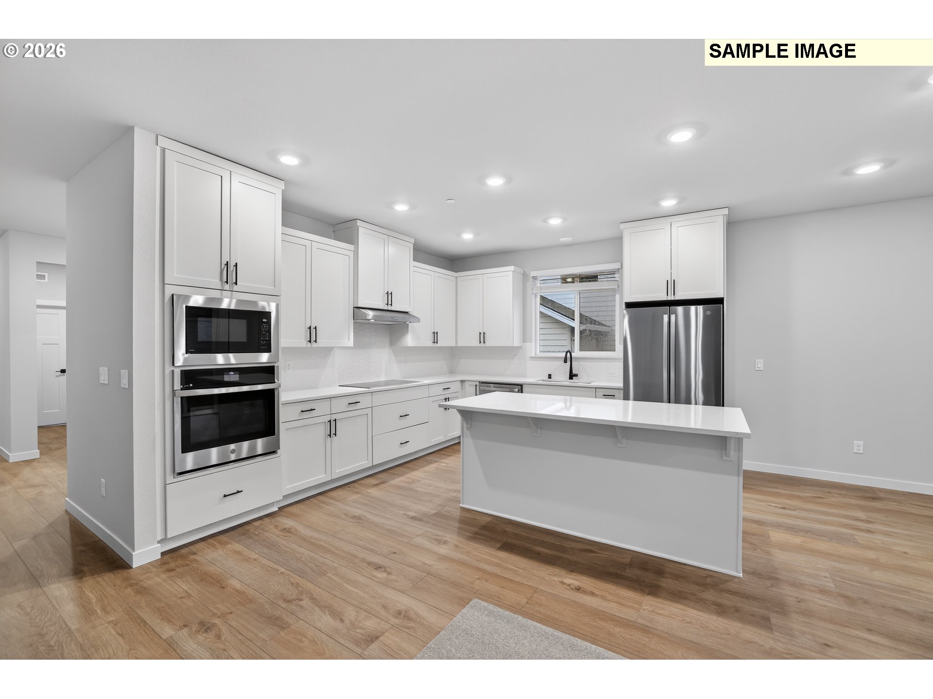 5272 North 87th Avenue Camas, WA 98607 - Photo 10 of 26 a view of kitchen with kitchen island stainless steel appliances a sink cabinets and wooden floor