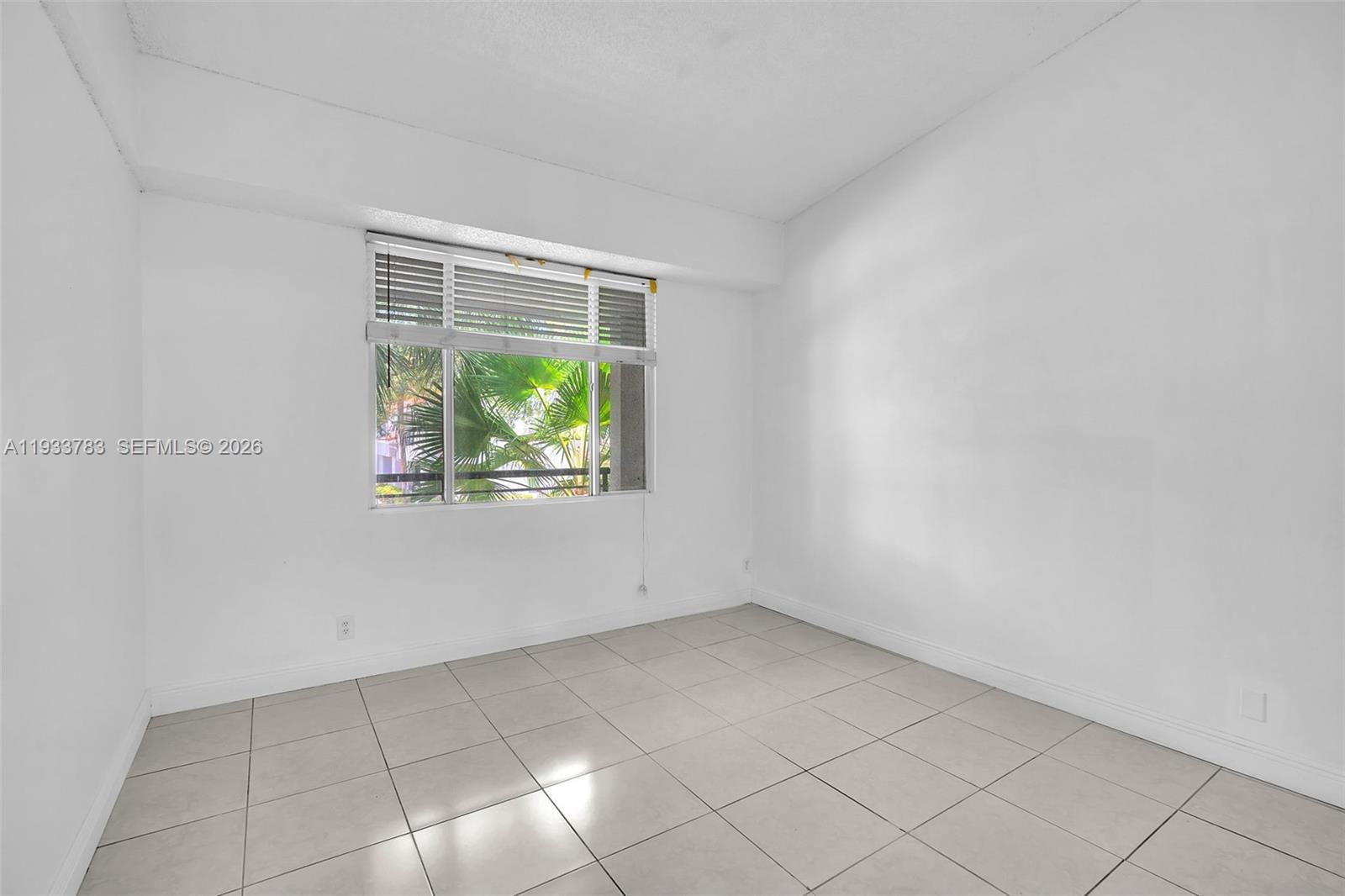 811 Lyons Road, Unit 20203 Coconut Creek, FL 33063 - Photo 11 of 21 a view of an empty room with a window