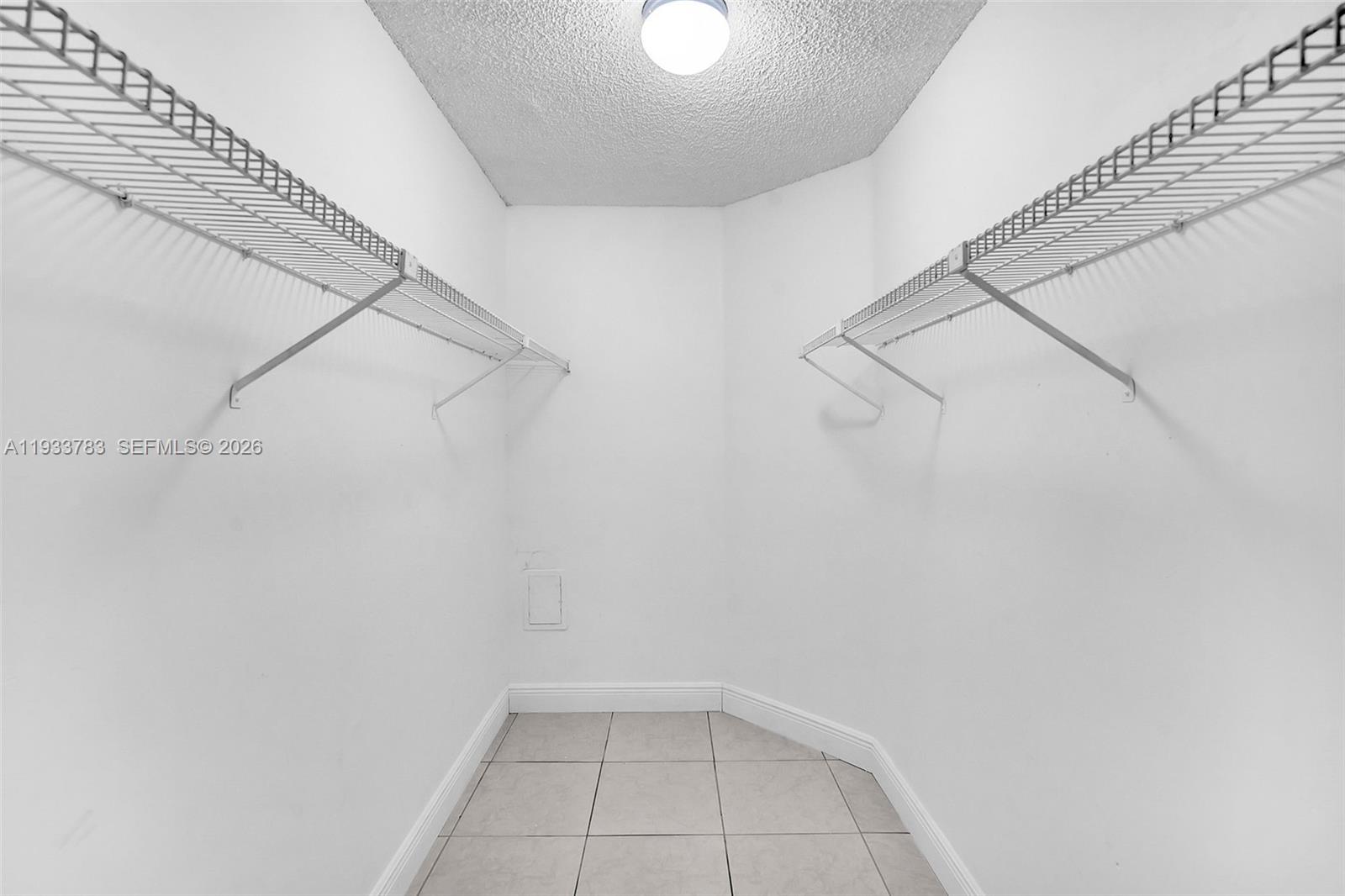811 Lyons Road, Unit 20203 Coconut Creek, FL 33063 - Photo 12 of 21 a view of a room with racks on the wall