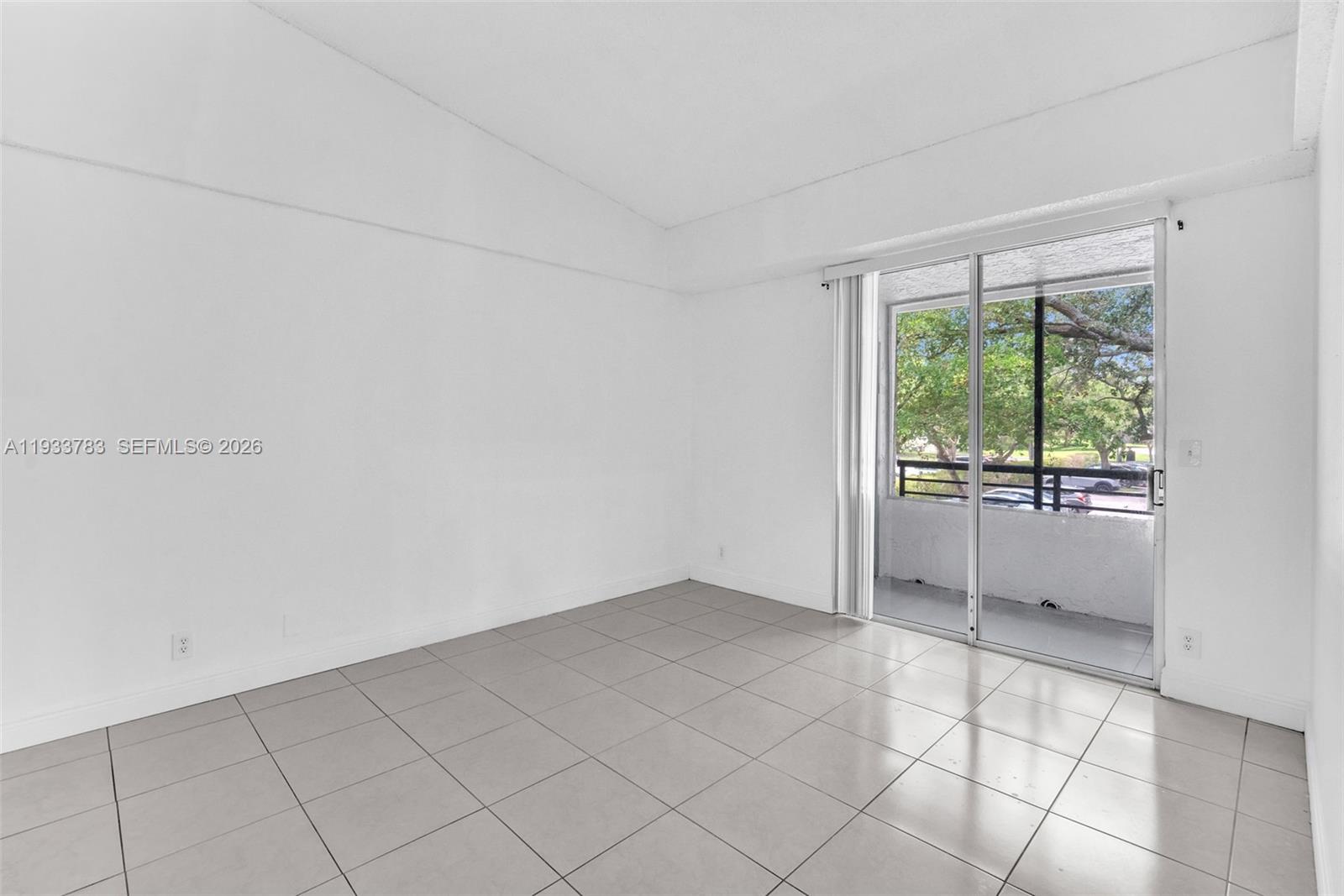 811 Lyons Road, Unit 20203 Coconut Creek, FL 33063 - Photo 13 of 21 a view of an empty room and window