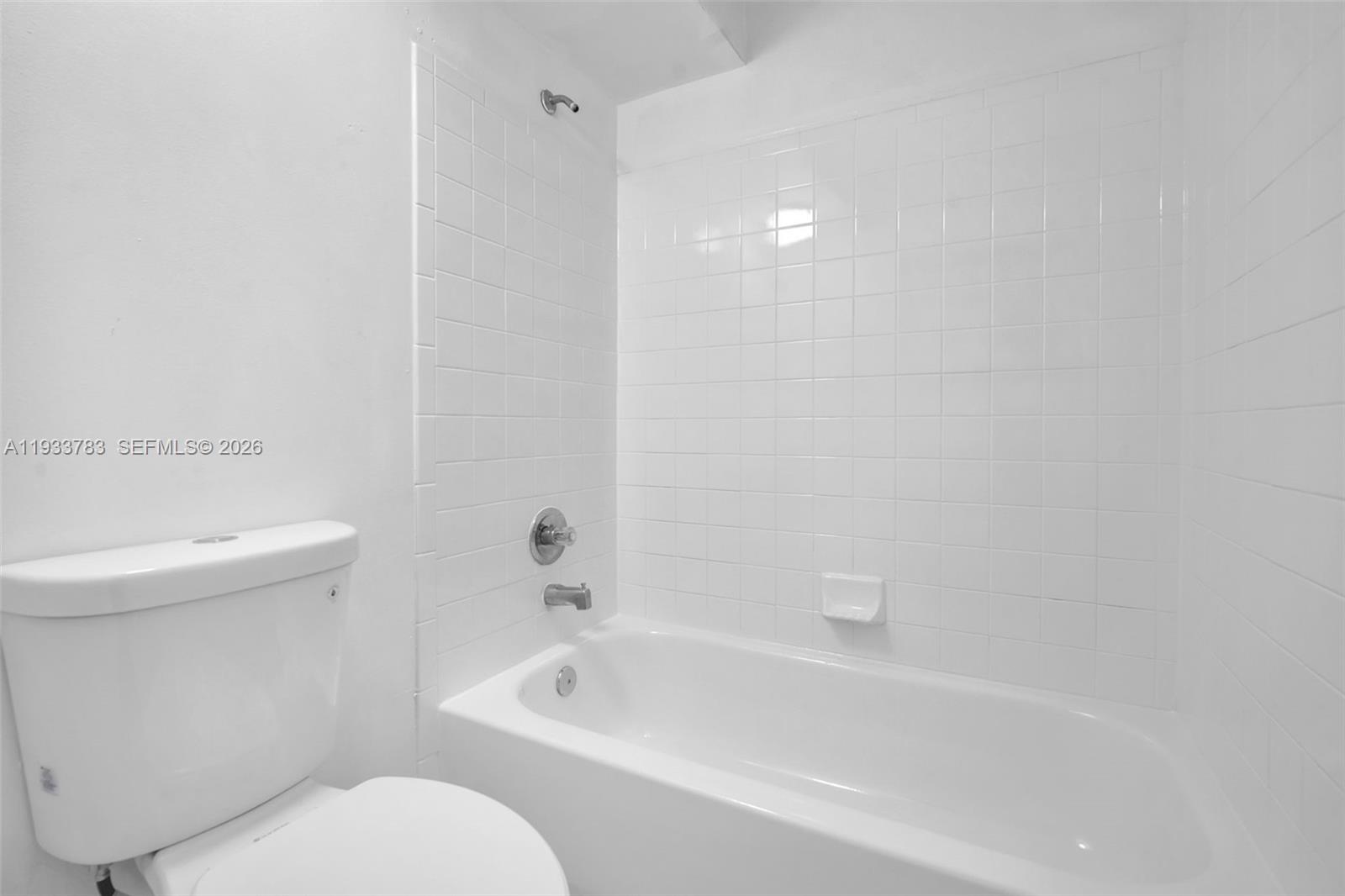 811 Lyons Road, Unit 20203 Coconut Creek, FL 33063 - Photo 16 of 21 a bathroom with a toilet and a bathtub