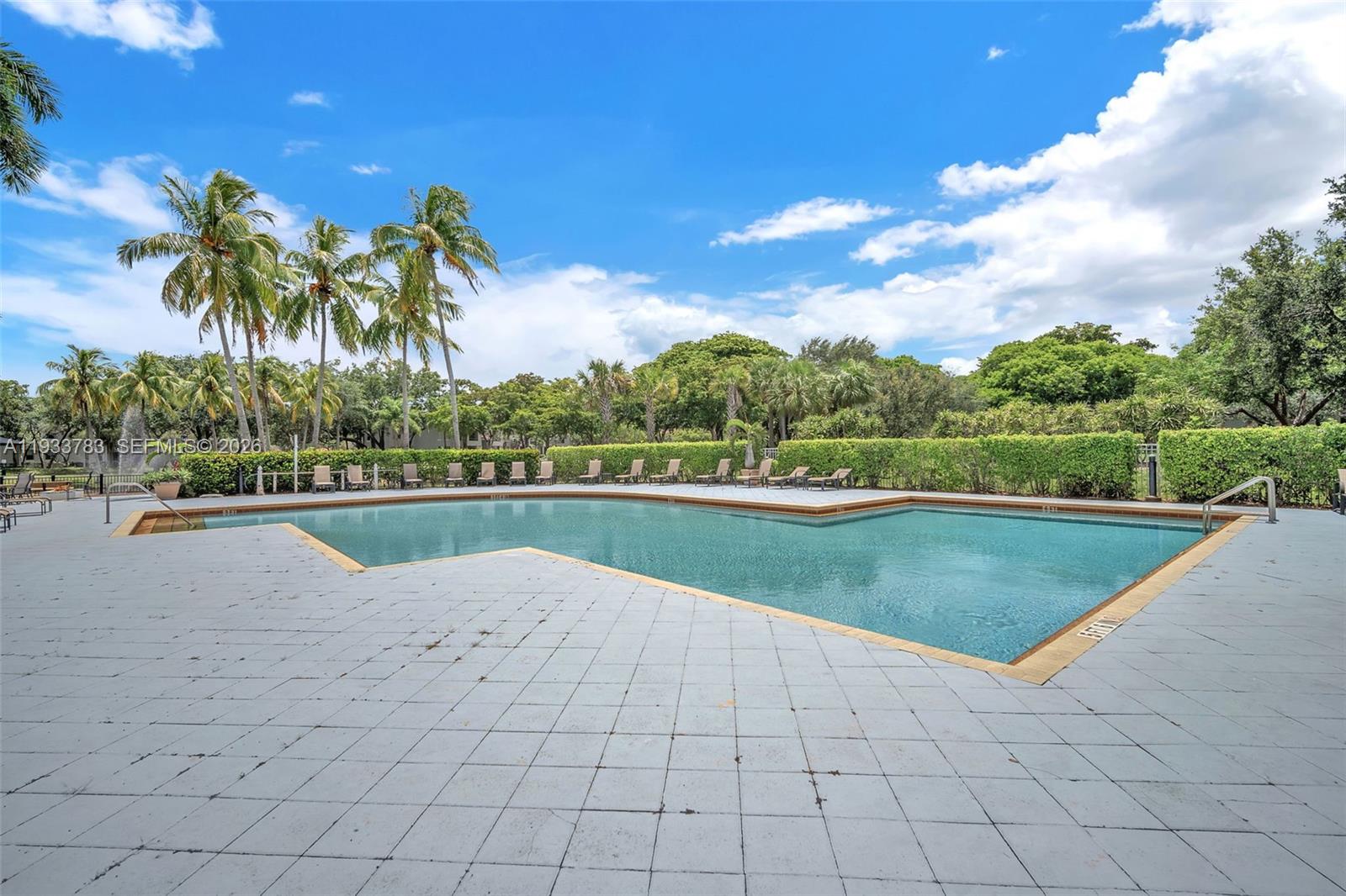 811 Lyons Road, Unit 20203 Coconut Creek, FL 33063 - Photo 18 of 21 a view of swimming pool with a yard
