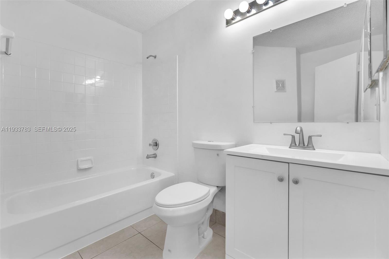 811 Lyons Road, Unit 20203 Coconut Creek, FL 33063 - Photo 19 of 23 a bathroom with a sink toilet and shower