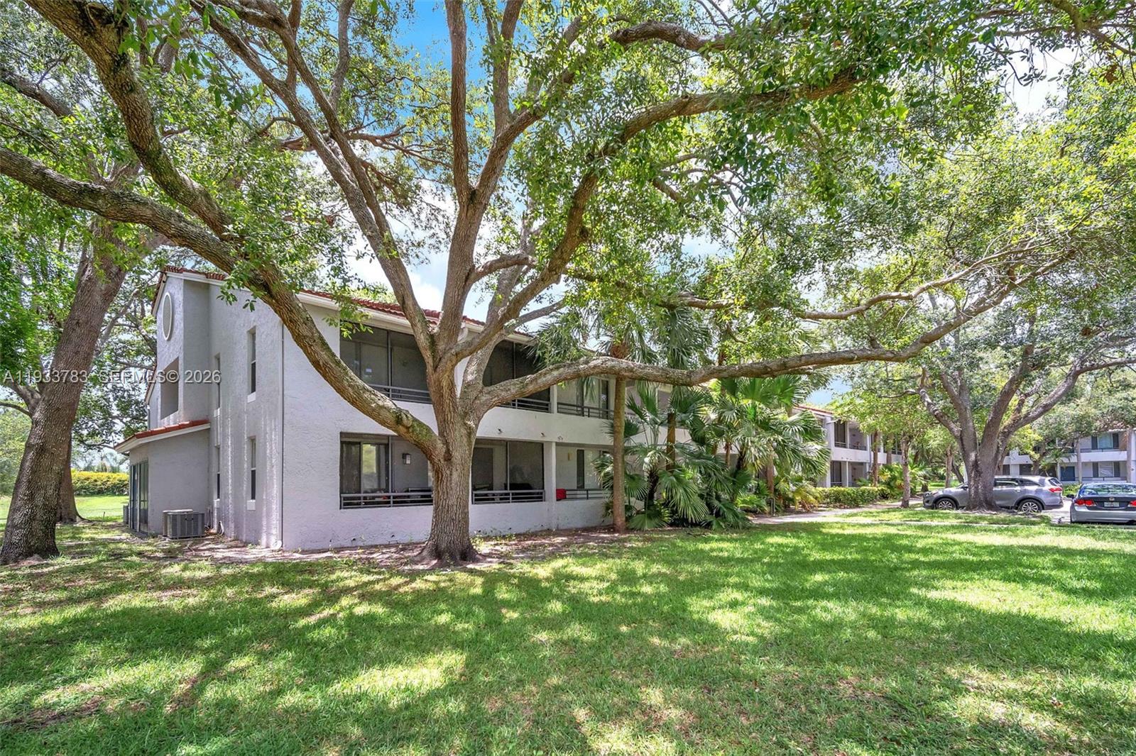 811 Lyons Road, Unit 20203 Coconut Creek, FL 33063 - Photo 20 of 21 a front view of a house with garden