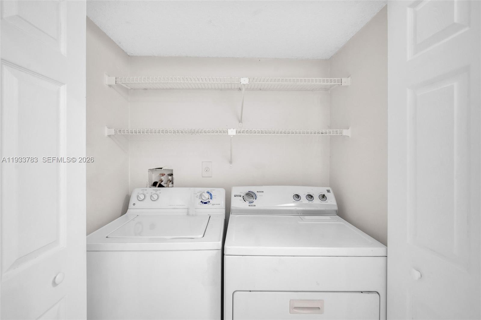 811 Lyons Road, Unit 20203 Coconut Creek, FL 33063 - Photo 4 of 21 a utility room with dryer and washer