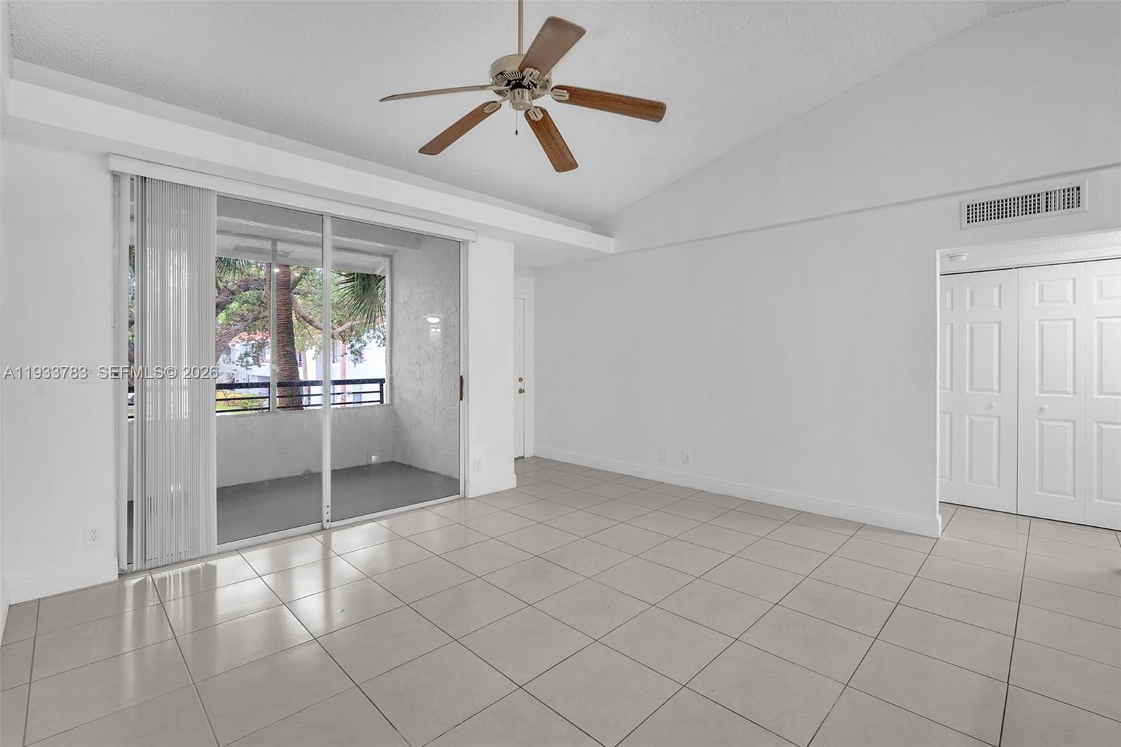 811 Lyons Road, Unit 20203 Coconut Creek, FL 33063 - Photo 5 of 21 a view of an empty room and window