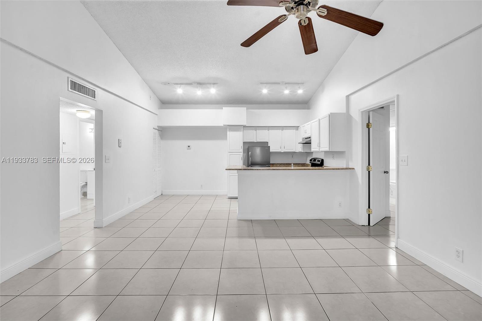 811 Lyons Road, Unit 20203 Coconut Creek, FL 33063 - Photo 6 of 21 a view of kitchen with stainless steel appliances cabinets and ceiling fan