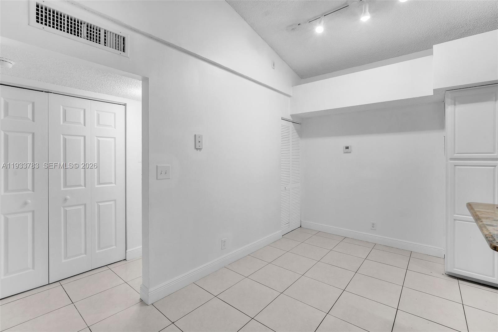 811 Lyons Road, Unit 20203 Coconut Creek, FL 33063 - Photo 10 of 21 a view of an empty room