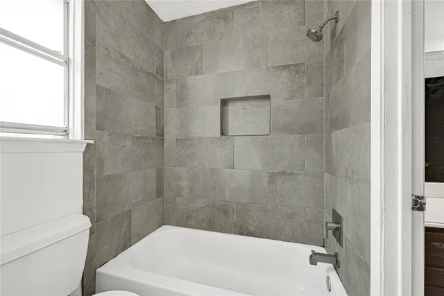 a bathroom with a white bath tub and a shower
