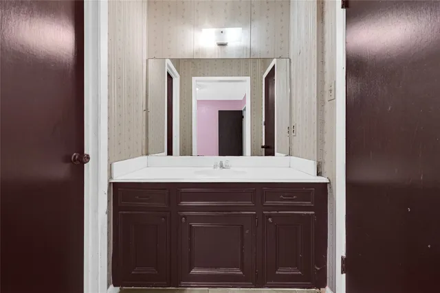 a bathroom with a sink and a mirror
