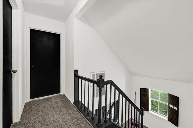 a view of a hallway with stairs to bedroom and stairs
