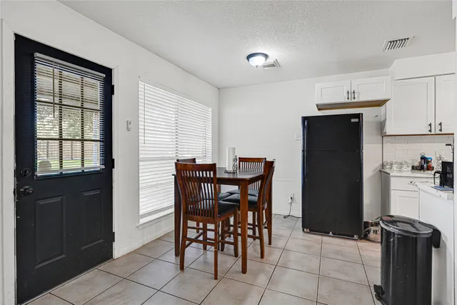 a view of a dining room with furniture and a window