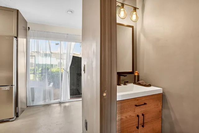 a bathroom with a sink a mirror and a shower