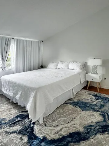 a bedroom with a bed and a flat tv screen