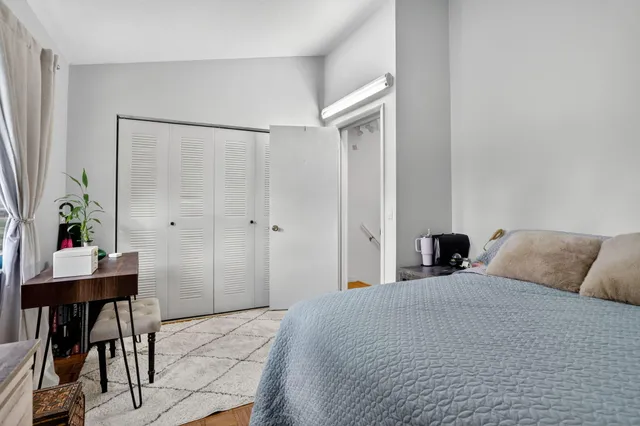 a bed room with a bed and a view of bedroom