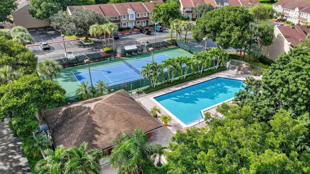 an aerial view of lake and residential houses with outdoor space