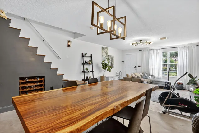 a room with gym equipment and wooden floor
