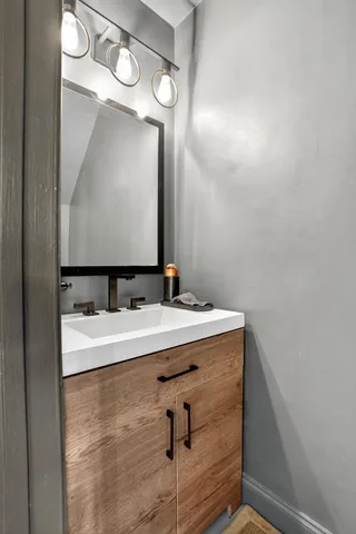 a bathroom with a sink and a mirror