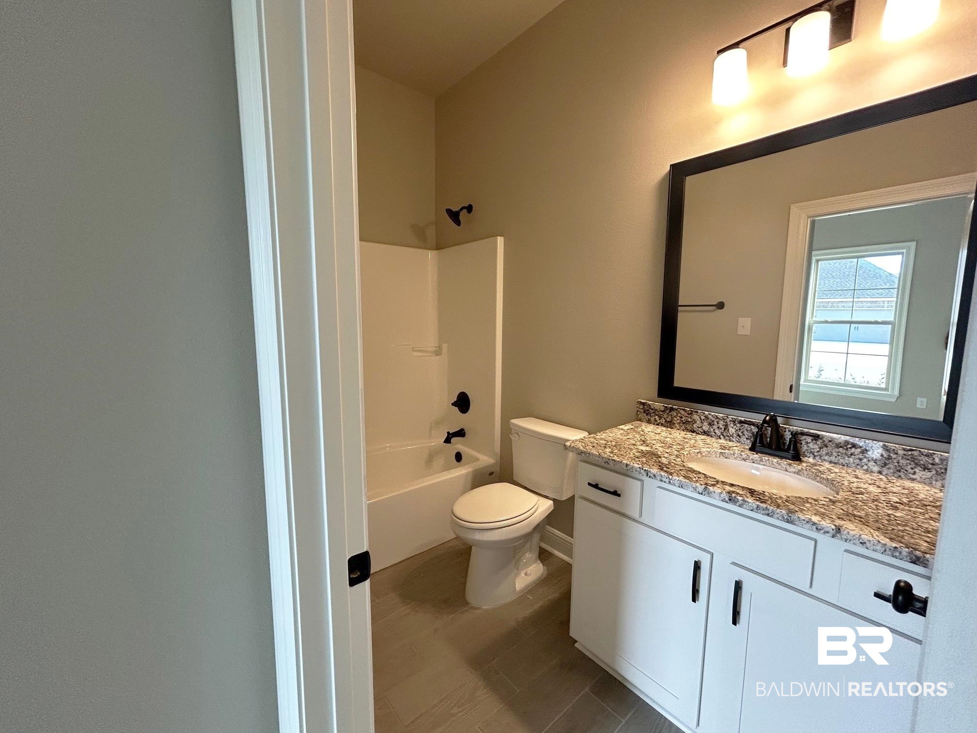 881 Sumter Loop Foley, AL 36535 - Photo 15 of 19 Full bathroom featuring vanity, toilet, and shower / tub combination