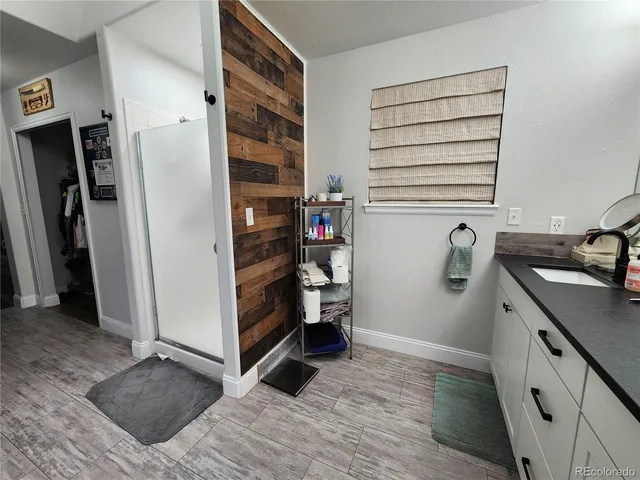 a bathroom with a double vanity sink a mirror and shower