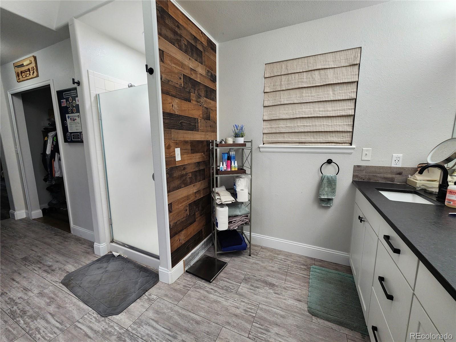 4745 Purcell Drive Colorado Springs, CO 80922 - Photo 12 of 25 a view of walk in closet with clothes and shoes