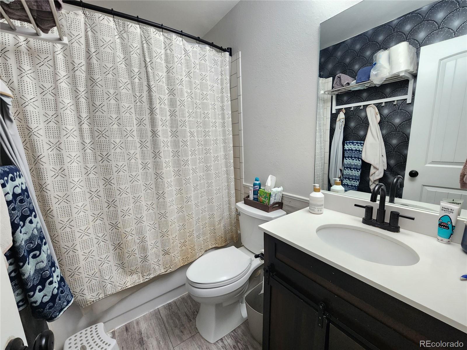4745 Purcell Drive Colorado Springs, CO 80922 - Photo 17 of 25 a bathroom with a sink and a mirror