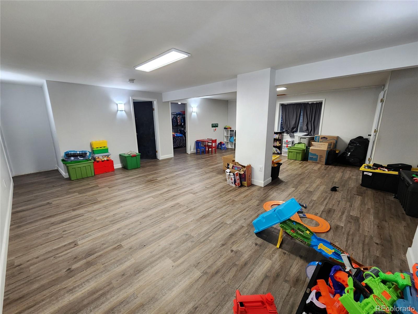 4745 Purcell Drive Colorado Springs, CO 80922 - Photo 20 of 25 a living room with furniture and a wooden floor