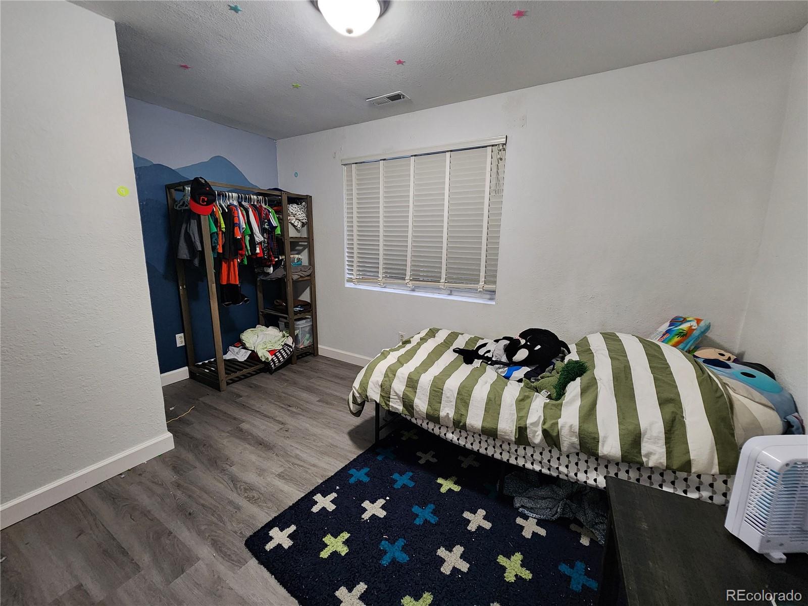 4745 Purcell Drive Colorado Springs, CO 80922 - Photo 21 of 25 a bed room with a bed and a closet