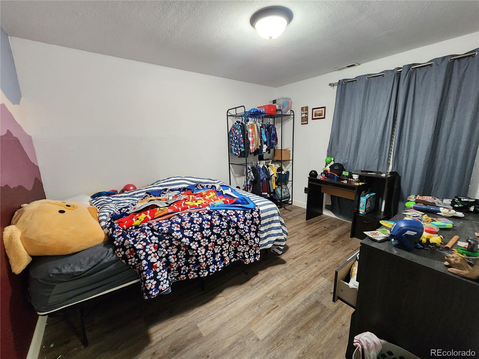 4745 Purcell Drive Colorado Springs, CO 80922 - Photo 23 of 25 a bedroom with bed and a window