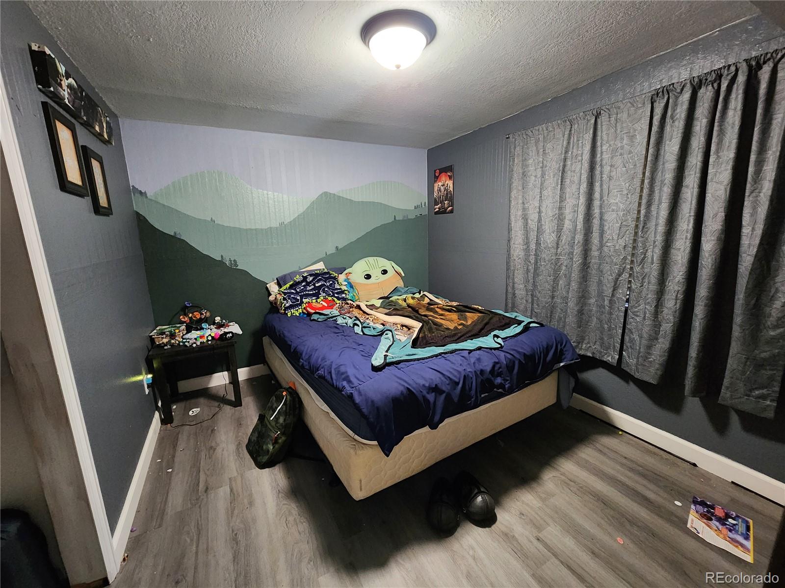 4745 Purcell Drive Colorado Springs, CO 80922 - Photo 24 of 25 a bedroom with a bed and a dresser