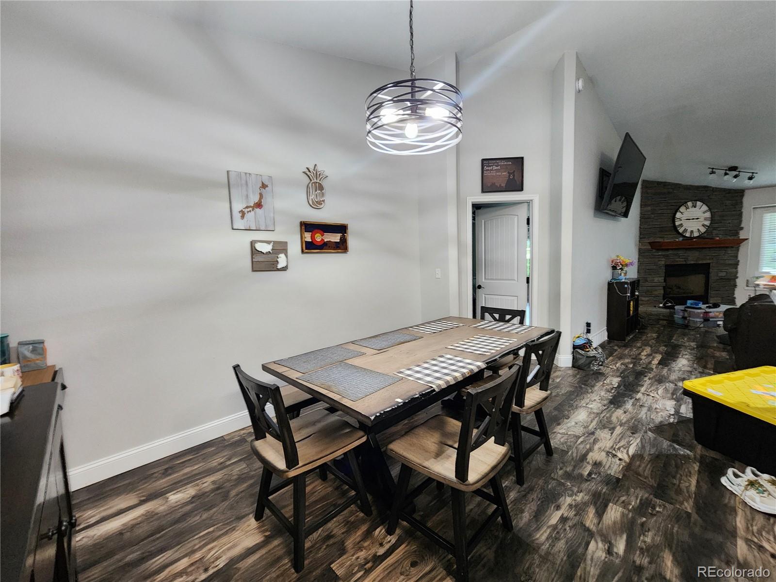 4745 Purcell Drive Colorado Springs, CO 80922 - Photo 6 of 25 a view of a dining room with furniture a chandelier and wooden floor
