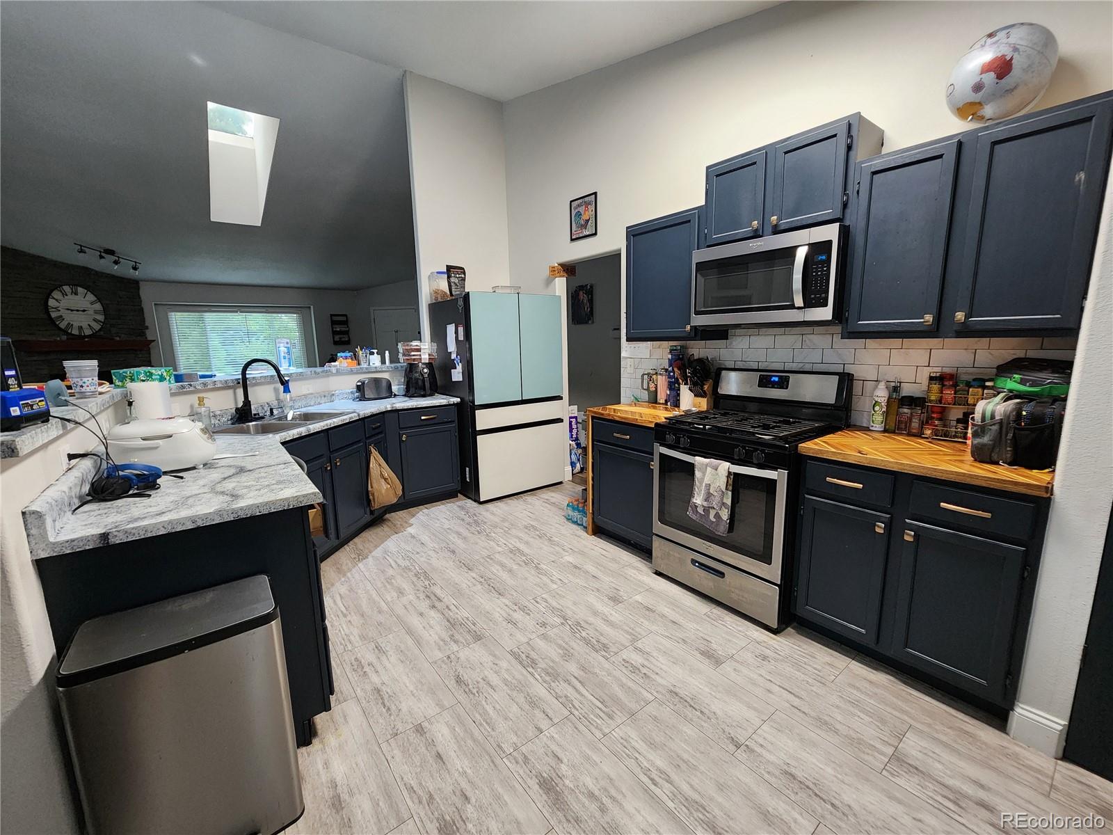 4745 Purcell Drive Colorado Springs, CO 80922 - Photo 7 of 25 a kitchen with stainless steel appliances granite countertop a sink stove and refrigerator