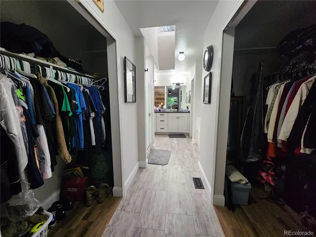 a view of walk in closet with clothes and shoes