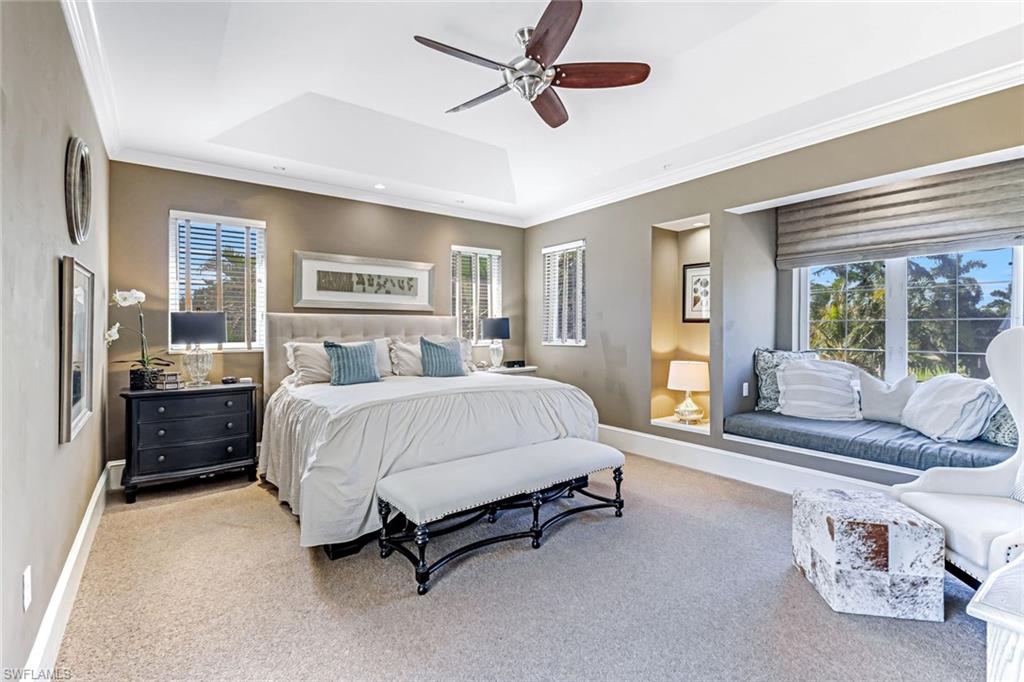 993 8th Street South, Unit 2 Naples, FL 34102 - Photo 11 of 28 a spacious bedroom with a bed and glass walk in closet