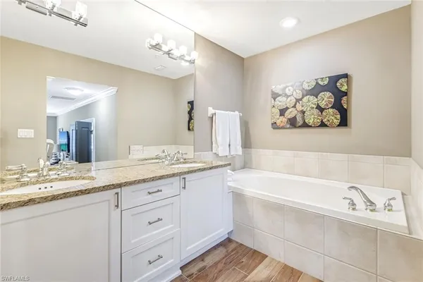 a bathroom with a sink a bathtub and a mirror