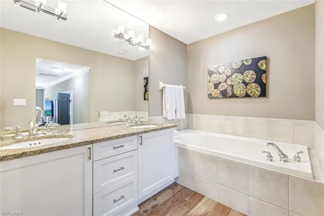 a bathroom with a sink a bathtub and a mirror