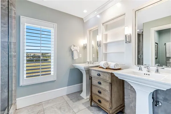 a spacious bathroom with a double vanity sink a mirror and a bathtub