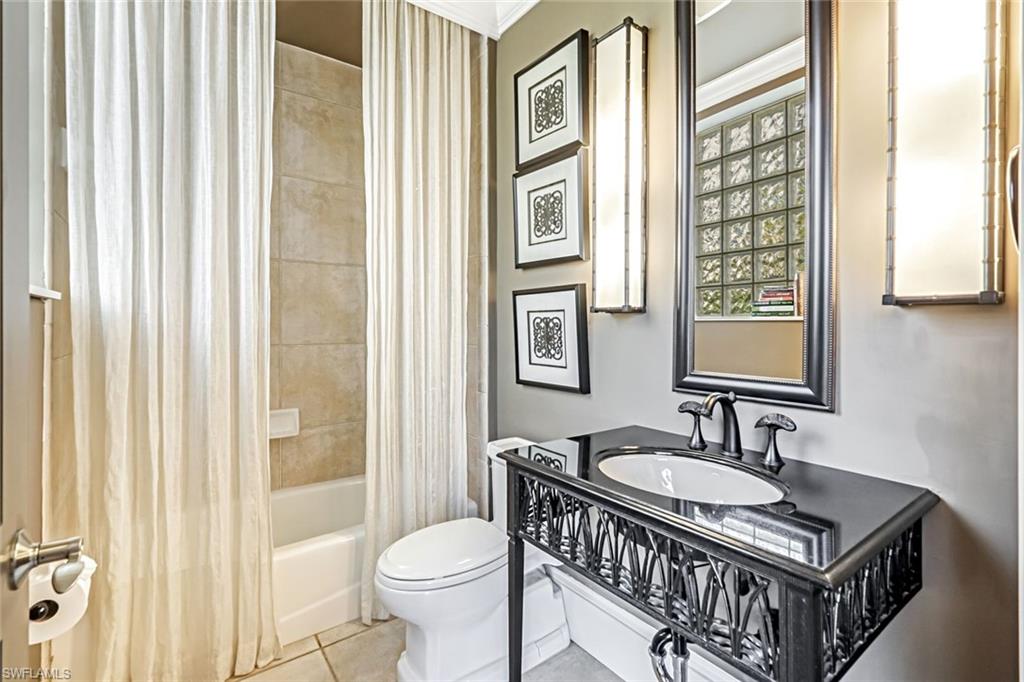 993 8th Street South, Unit 2 Naples, FL 34102 - Photo 22 of 28 a bathroom with a sink a toilet and shower