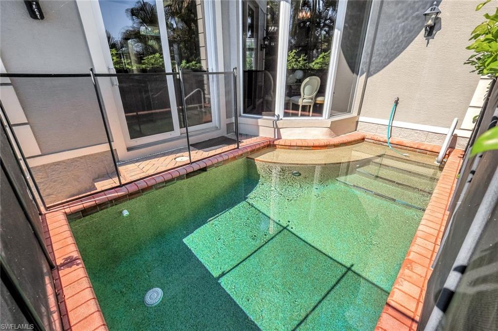 993 8th Street South, Unit 2 Naples, FL 34102 - Photo 24 of 28 a view of a swimming pool with a backyard