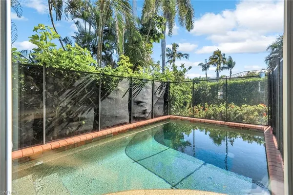 a view of a swimming pool with a yard and sitting area