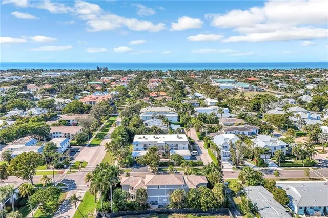 an aerial view of residential building with green space