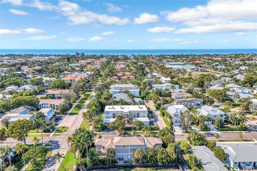 993 8th Street South, Unit 2 Naples, FL 34102 - Photo 26 of 28 an aerial view of residential building with green space