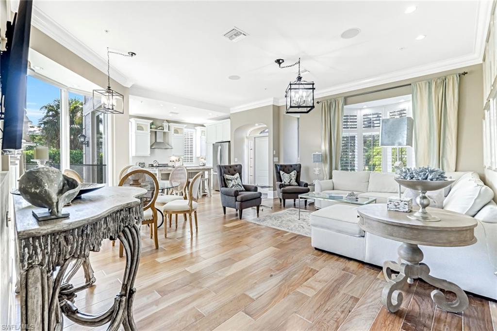 993 8th Street South, Unit 2 Naples, FL 34102 - Photo 3 of 28 a living room with lots of furniture and a chandelier