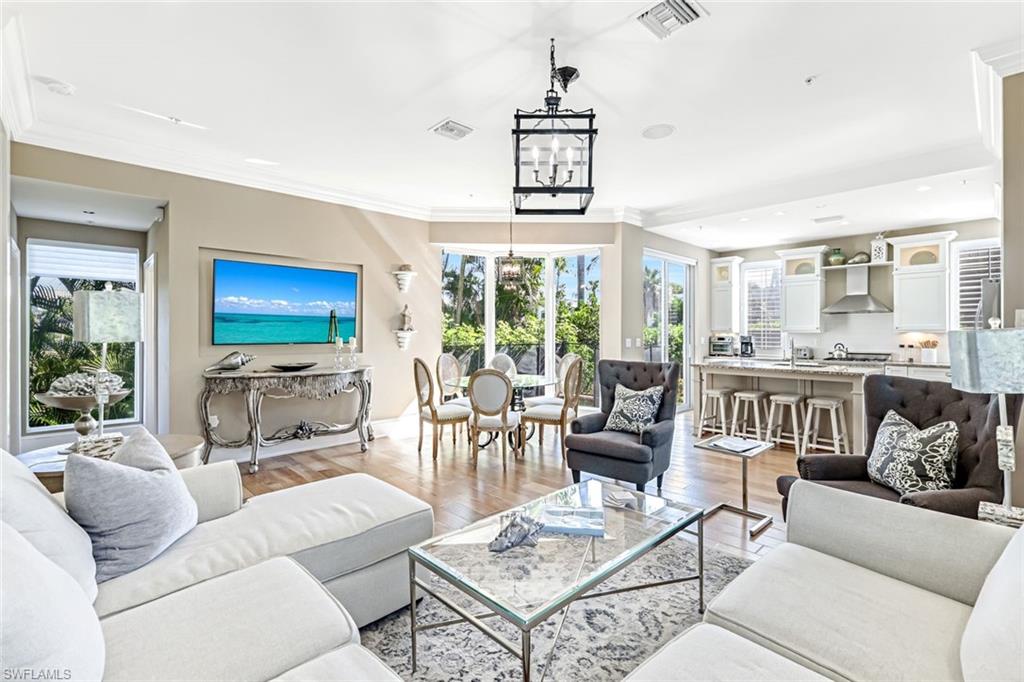 993 8th Street South, Unit 2 Naples, FL 34102 - Photo 4 of 28 a living room with furniture and a large window