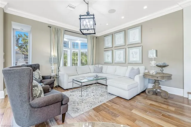 a living room with furniture and a chandelier